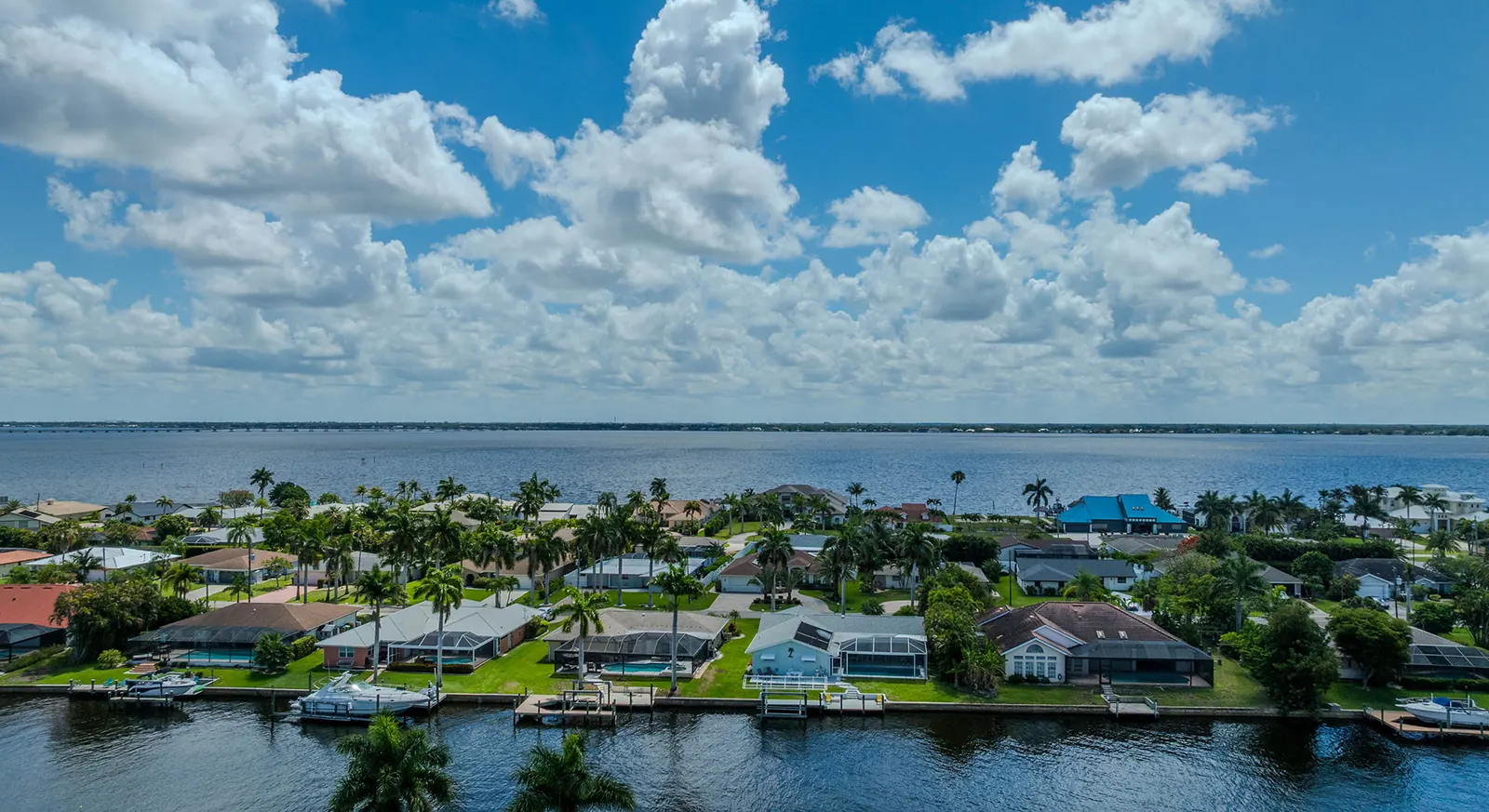 Aerial view of Cape Coral canal-front homes with private docks and seawalls