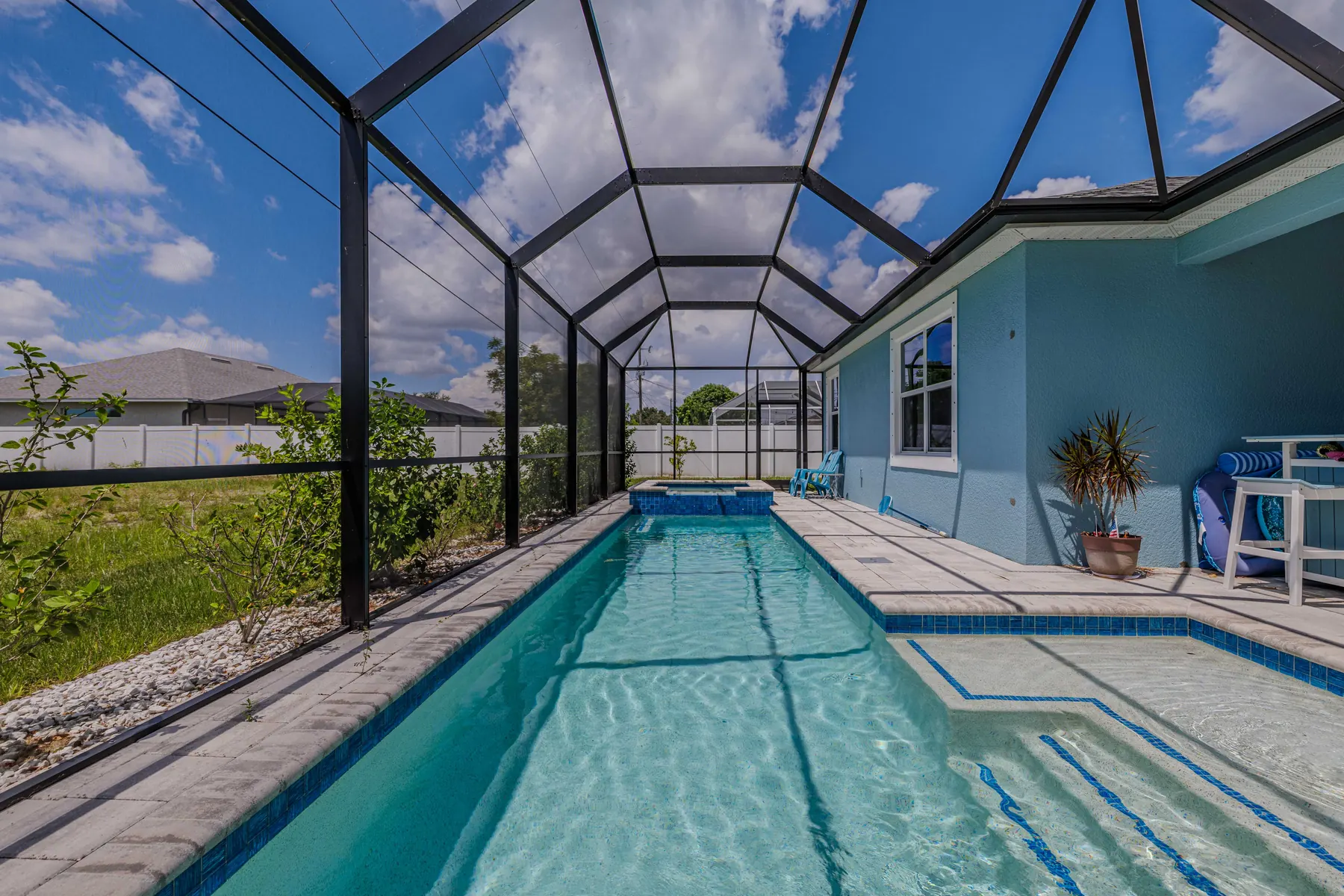 Heated pool under the screened enclosure, seen from the house