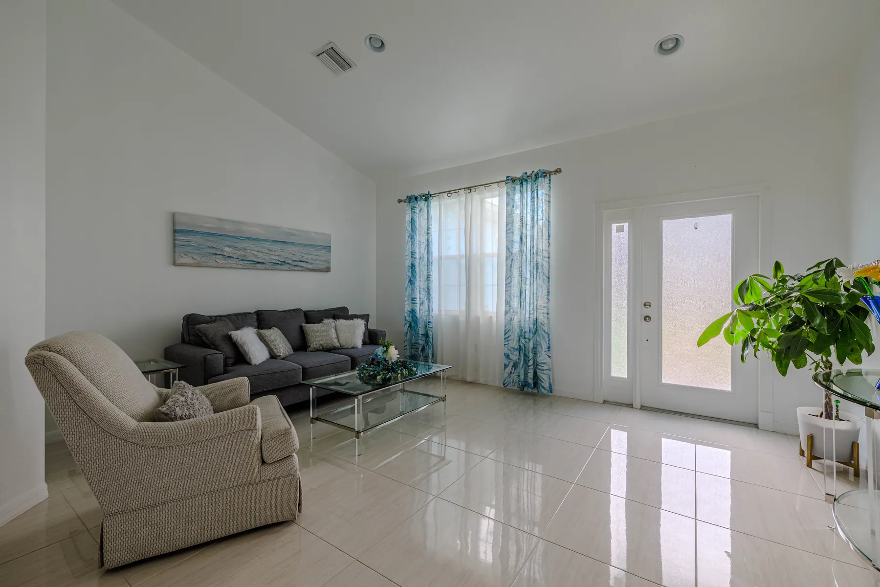 Living room with high ceilings and tile floors