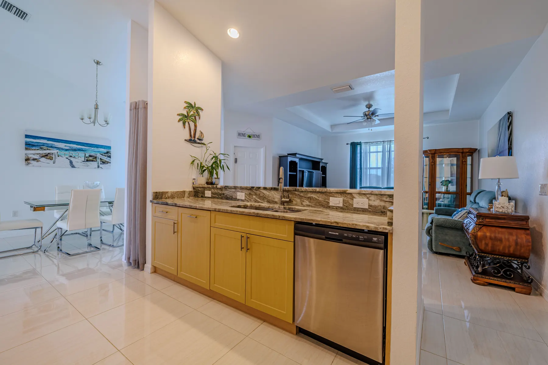 Kitchen with granite counters and bar seating, open to the living area
