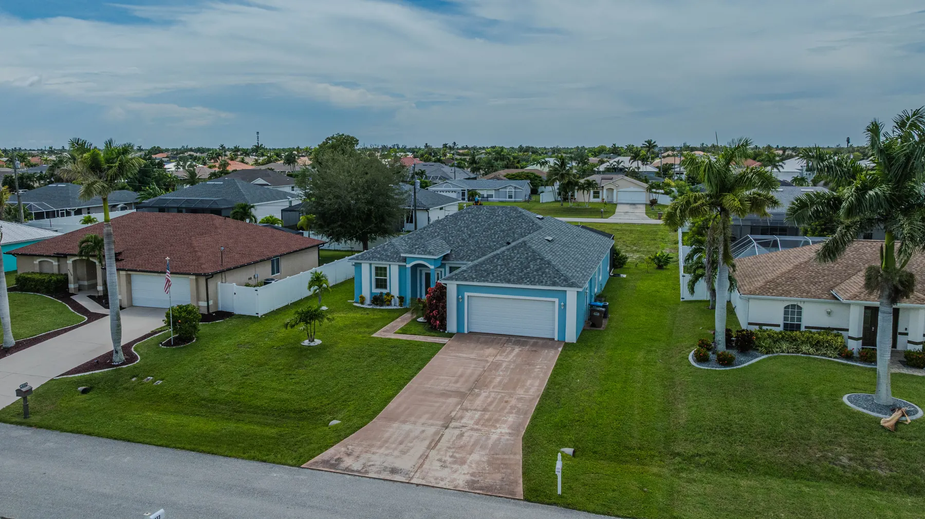 Aerial view of the home and driveway from the street