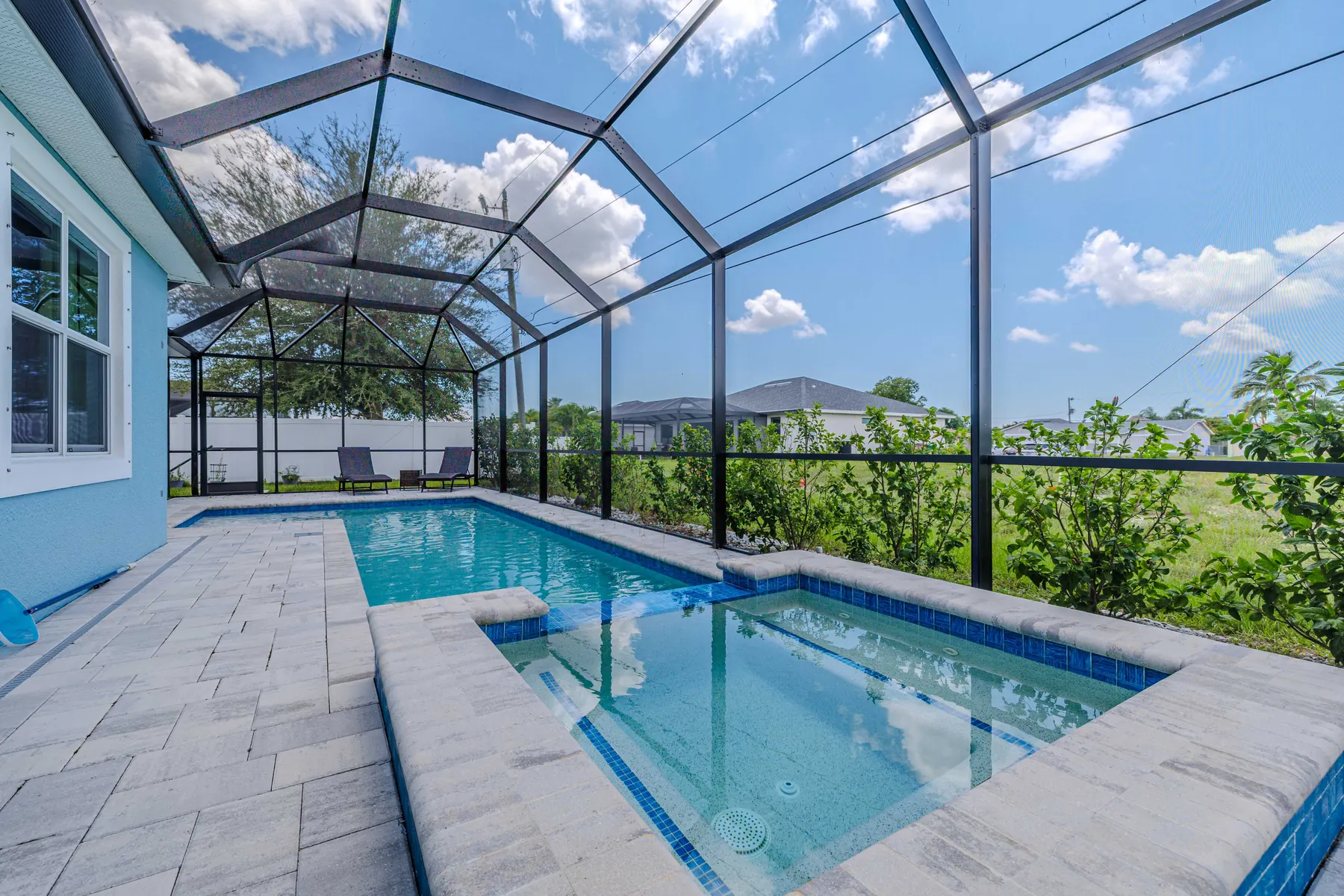 Pool with sun shelf and pavered deck
