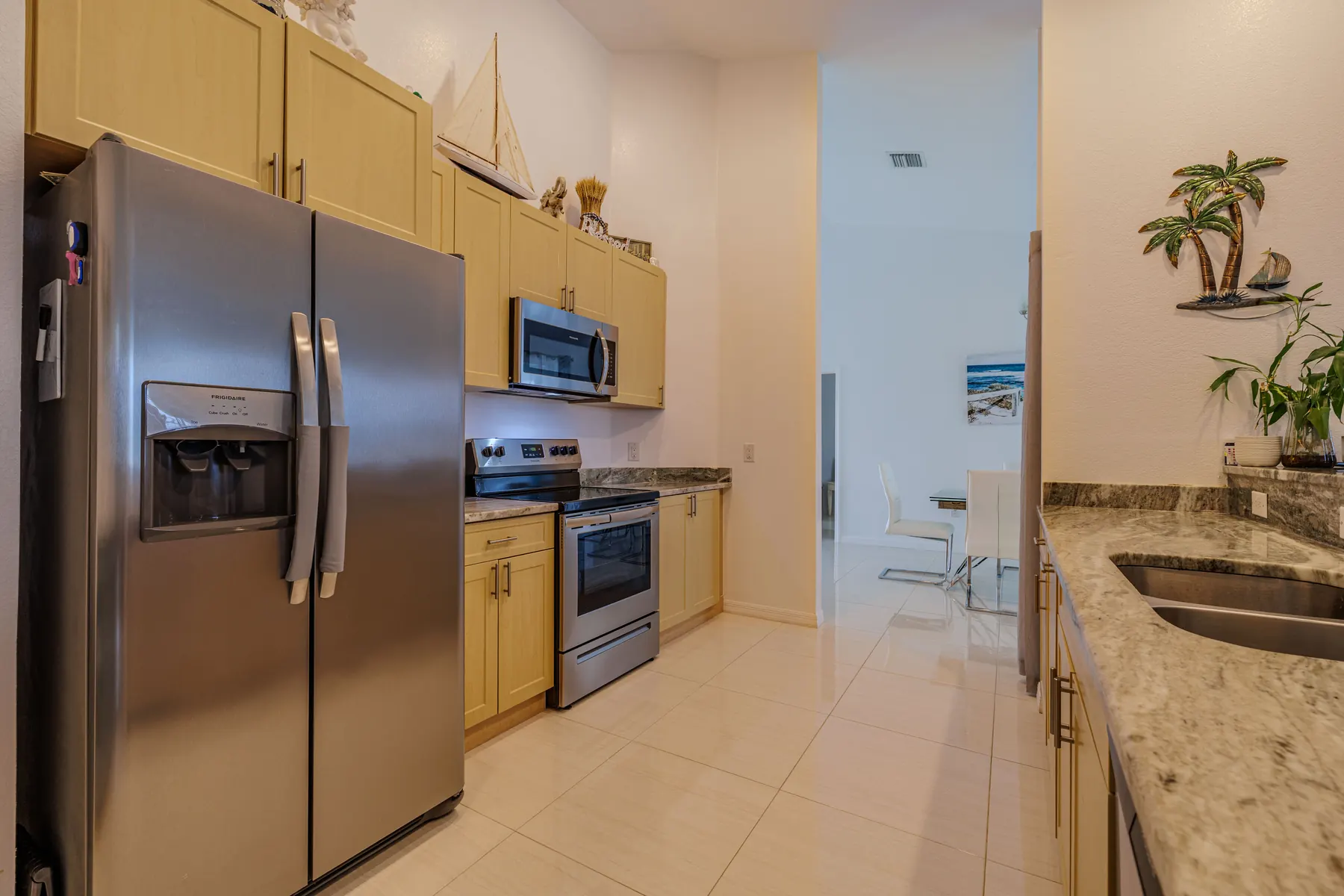Kitchen with side-by-side refrigerator and breakfast bar