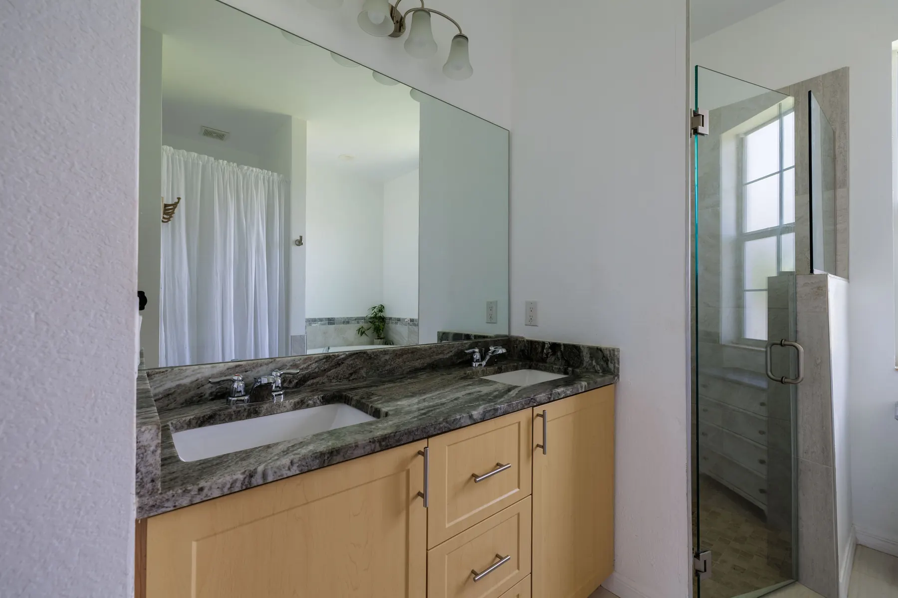 Primary bathroom vanity with granite top