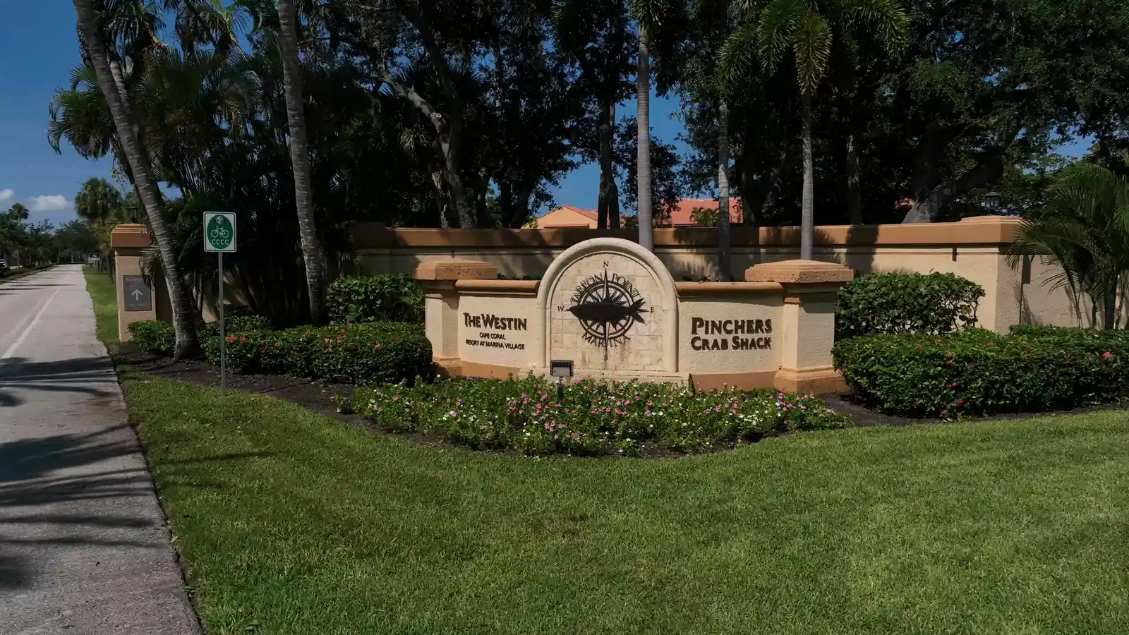 Tarpon Point Marina entrance sign, Cape Coral, framed by palms